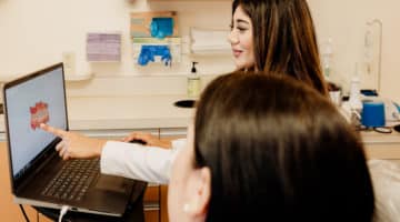 A doctor communicating with a patient in the chair