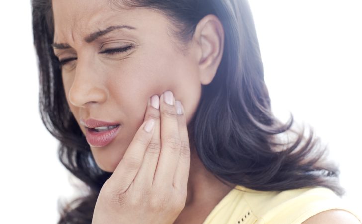 Woman feels TMJ in her jaw