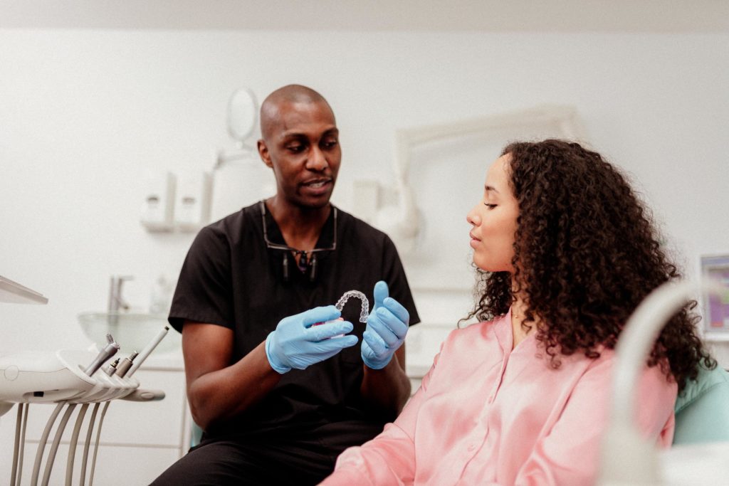 Dental professional showing Clear Aligners to a patient